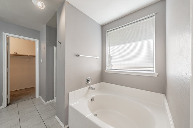 bathroom featuring tiled bath and tile patterned floors