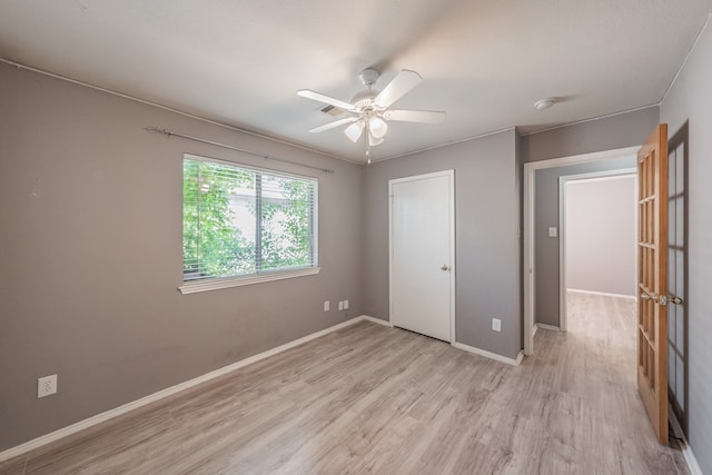 unfurnished bedroom with a closet, ceiling fan, and light wood-type flooring