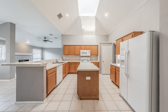 kitchen with white appliances, a fireplace, a kitchen island, high vaulted ceiling, and ceiling fan