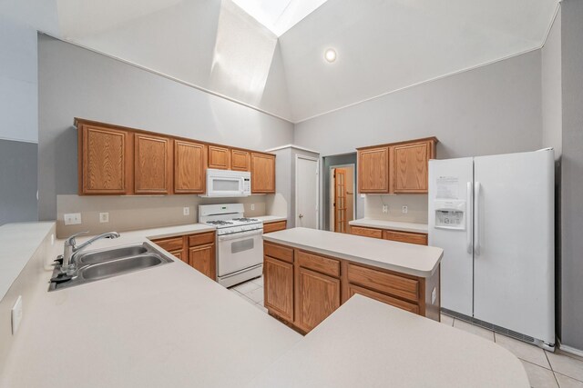 kitchen featuring light tile patterned floors, white appliances, sink, and high vaulted ceiling