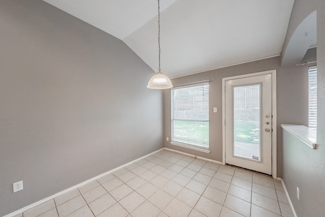 tiled spare room with lofted ceiling