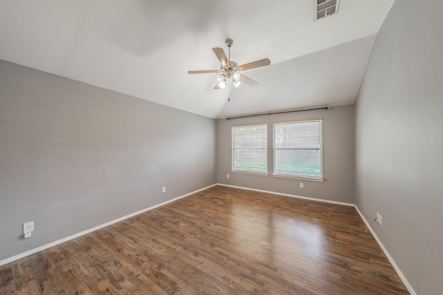 unfurnished room with dark hardwood / wood-style flooring, lofted ceiling, and ceiling fan