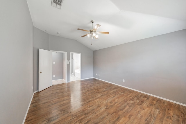 unfurnished bedroom featuring wood-type flooring, lofted ceiling, ceiling fan, and ensuite bath