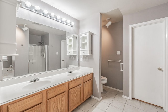 bathroom with tile patterned flooring, vanity, walk in shower, and toilet