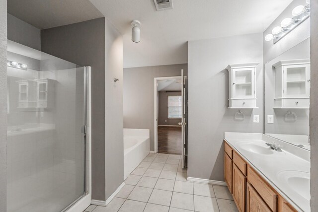 bathroom with double vanity, shower with separate bathtub, and hardwood / wood-style flooring