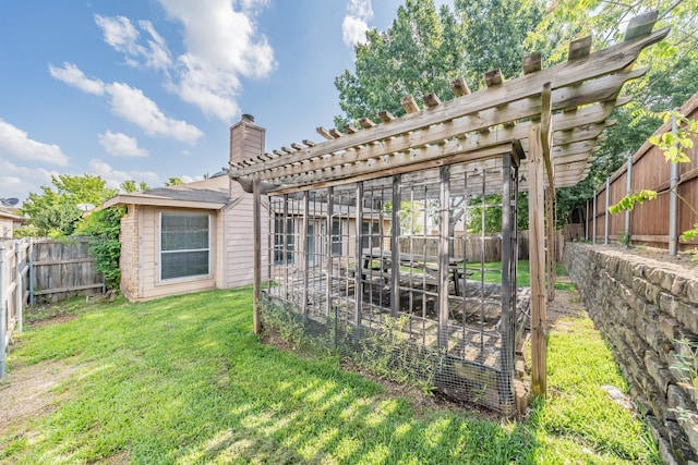 back of house with a yard and a pergola