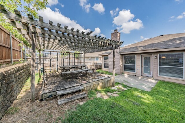 view of yard featuring a wooden deck, a patio area, and a pergola