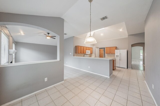 kitchen featuring ceiling fan, kitchen peninsula, pendant lighting, white appliances, and light tile patterned floors