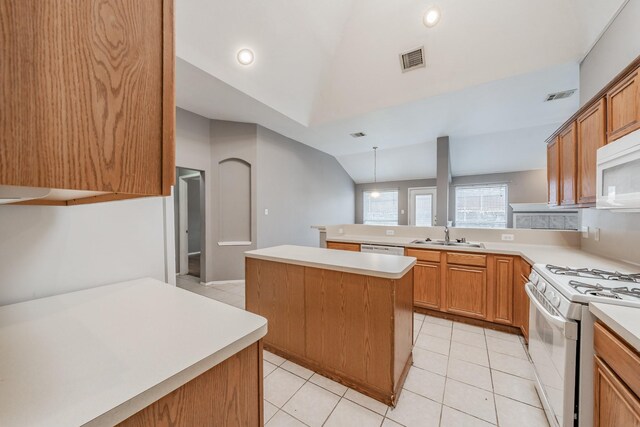 kitchen featuring white appliances, sink, a kitchen island, lofted ceiling, and light tile patterned flooring