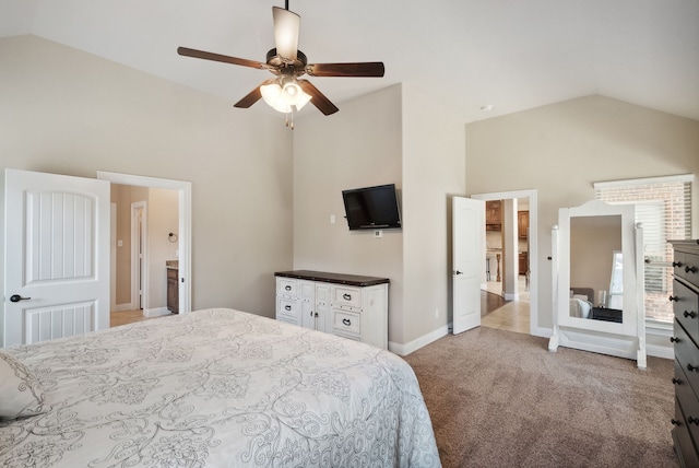 carpeted bedroom with ensuite bathroom, ceiling fan, and vaulted ceiling