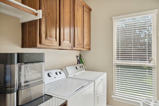 laundry area with washer and clothes dryer and cabinets