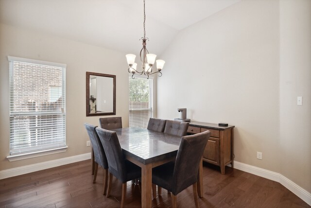 dining area featuring a chandelier, dark hardwood / wood-style flooring, and lofted ceiling