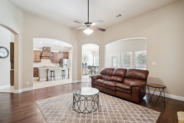 tiled living room featuring ceiling fan