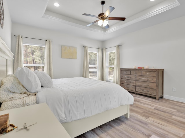 bedroom featuring crown molding, ceiling fan, hardwood / wood-style floors, and a tray ceiling