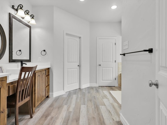 bathroom featuring wood-type flooring and vanity