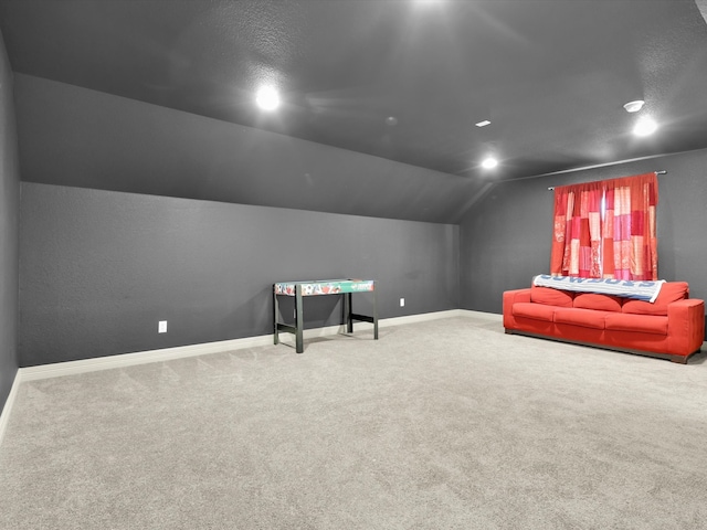 rec room featuring carpet flooring and vaulted ceiling