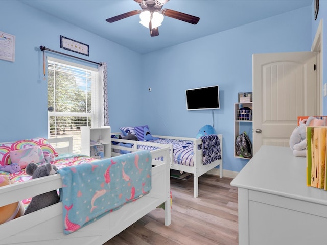 bedroom with ceiling fan and light hardwood / wood-style flooring