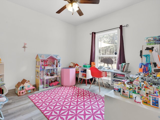 playroom with light hardwood / wood-style floors and ceiling fan