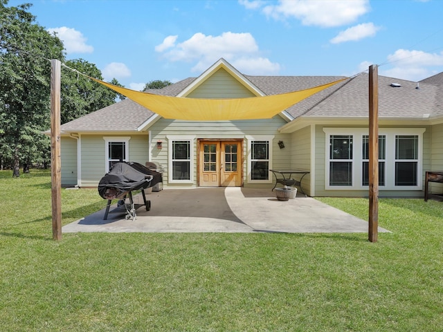 back of property with a patio and a yard