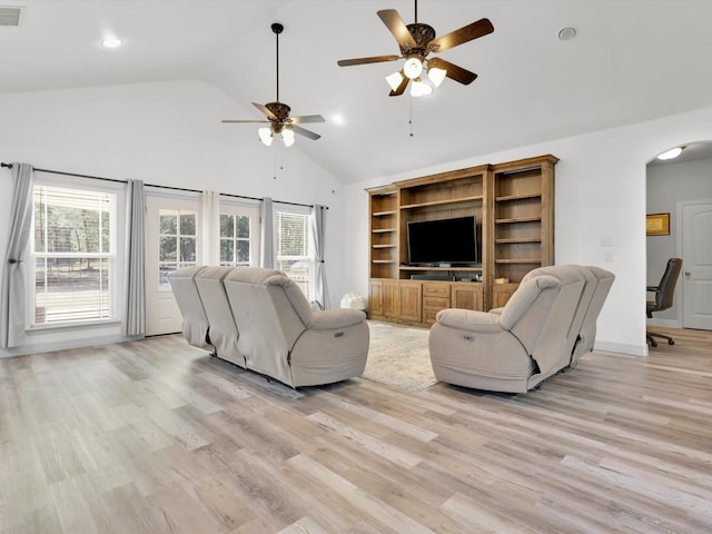 living room with high vaulted ceiling, ceiling fan, and light wood-type flooring