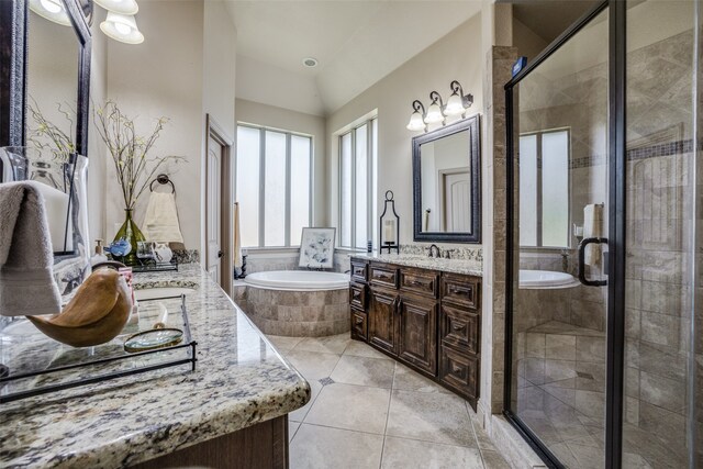 bathroom featuring vanity, tile patterned flooring, and separate shower and tub