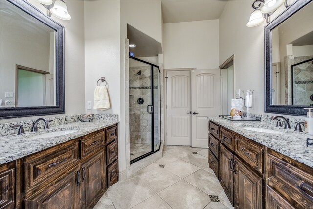 bathroom featuring vanity, tile patterned flooring, and an enclosed shower