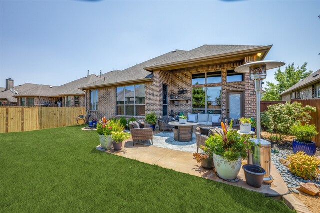 back of property featuring outdoor lounge area, a lawn, and a patio area