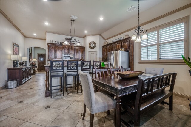 tiled dining area with a notable chandelier and ornamental molding