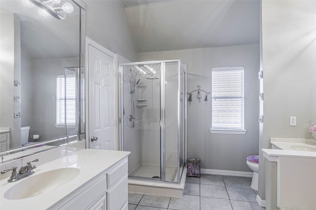 bathroom featuring vanity, toilet, tile patterned flooring, and vaulted ceiling