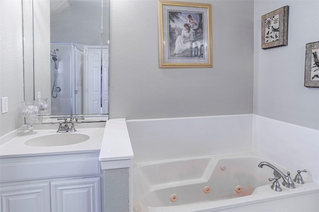 bathroom featuring a jetted tub, a shower stall, and vanity