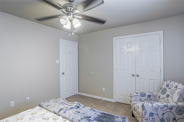 carpeted bedroom featuring a ceiling fan, a closet, and baseboards