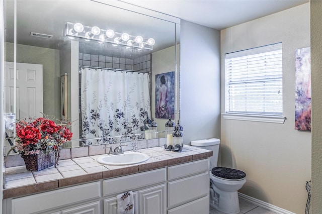 bathroom with visible vents, a shower with shower curtain, toilet, vanity, and tile patterned floors