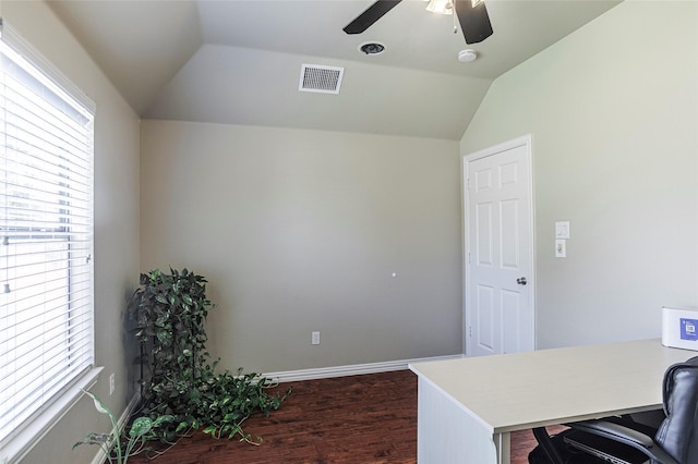 home office with lofted ceiling, plenty of natural light, visible vents, and dark wood-style flooring