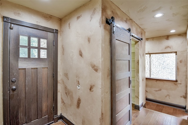 doorway featuring wood-type flooring and a barn door