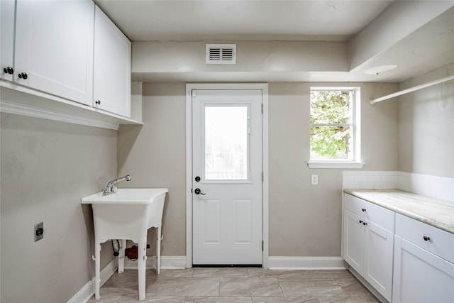 laundry room with cabinets and electric dryer hookup