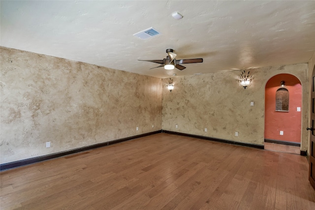 unfurnished room with hardwood / wood-style flooring and ceiling fan