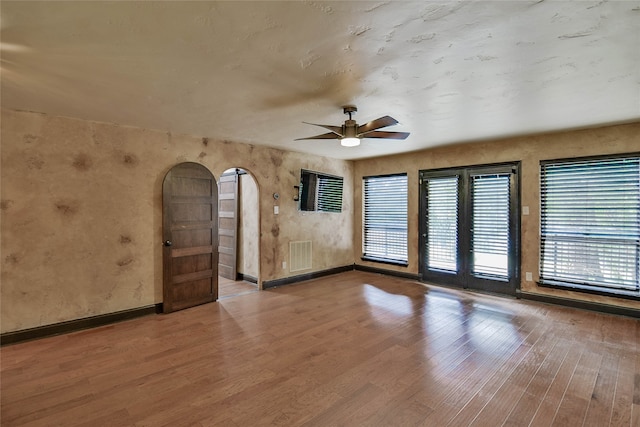 empty room featuring ceiling fan and hardwood / wood-style floors