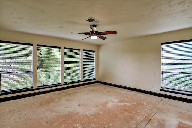 spare room with a wealth of natural light and ceiling fan