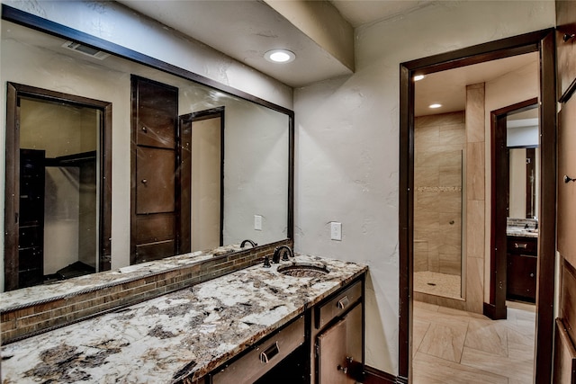 bathroom featuring a shower and vanity