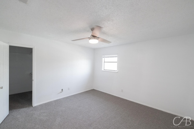 unfurnished room with a textured ceiling, ceiling fan, and carpet