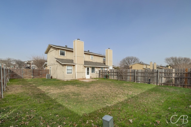 back of house featuring cooling unit and a yard