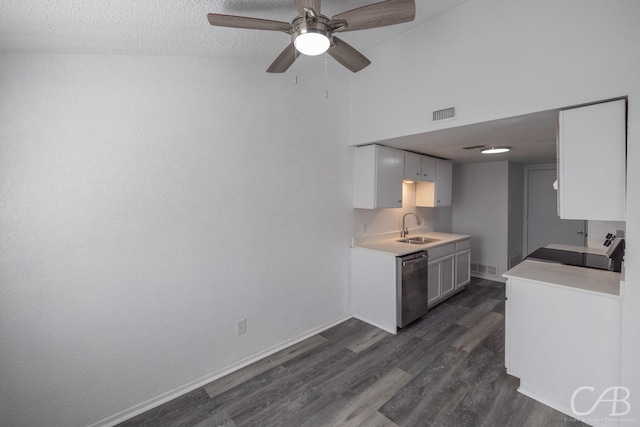 kitchen with stainless steel dishwasher, stove, sink, dark wood-type flooring, and white cabinets