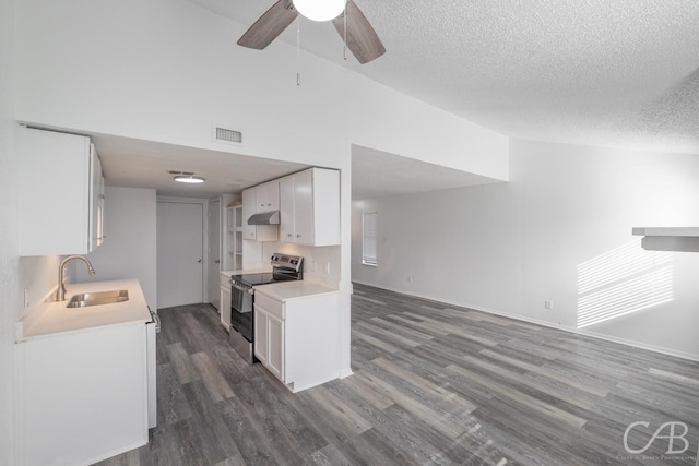 kitchen with hardwood / wood-style floors, electric range, a textured ceiling, white cabinets, and sink