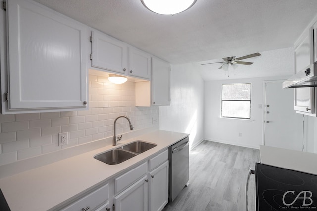 kitchen with electric range oven, white cabinets, dishwasher, sink, and backsplash