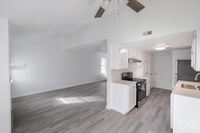 kitchen with light hardwood / wood-style floors, sink, white cabinetry, and stainless steel appliances