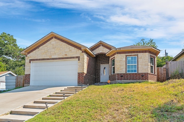 view of front of house featuring a garage and a front lawn