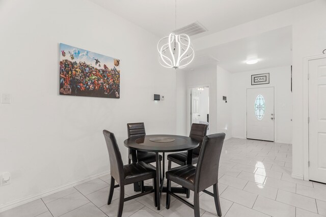 tiled dining space featuring a notable chandelier