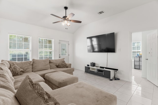 tiled living room featuring plenty of natural light, ceiling fan, and lofted ceiling