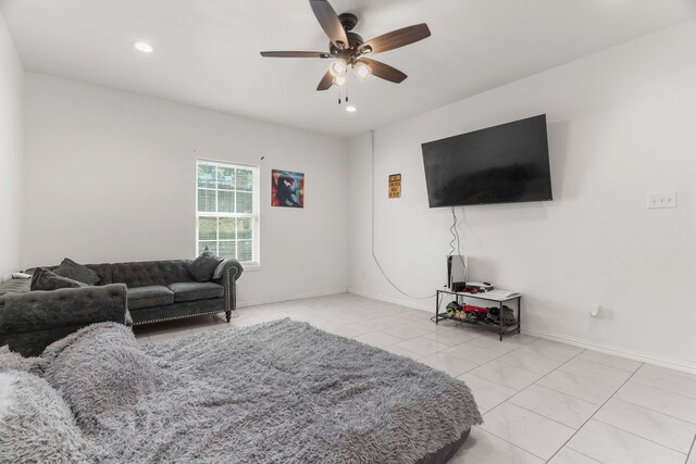 living room featuring light tile patterned floors and ceiling fan