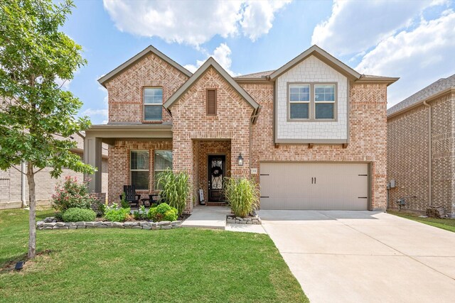 view of front of property featuring a garage and a front lawn